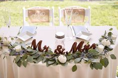 the table is set with two mr and mrs signs