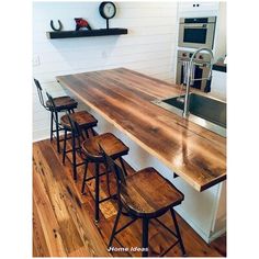 a kitchen island made out of wood with four stools