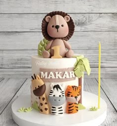 a birthday cake decorated with animals and a lion