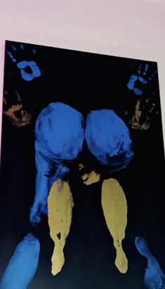 an image of two feet with blue and yellow paint on them