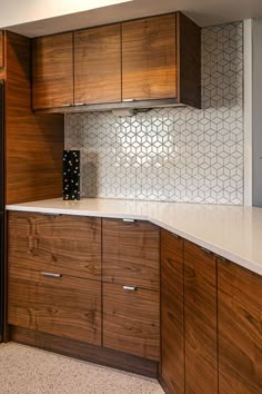 a kitchen with wooden cabinets and white counter tops