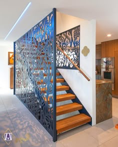 a stair case in the middle of a room with wooden steps and metal railings