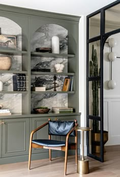 a living room filled with lots of furniture and bookshelves covered in marble tiles