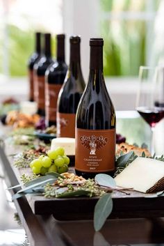 several bottles of wine and cheese on a table