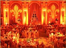 an image of a banquet hall setting with orange lighting