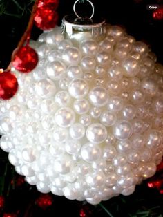 a white ornament hanging from a christmas tree