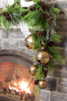 a fireplace with christmas decorations hanging from it's mantle