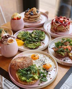 a table topped with plates filled with breakfast foods