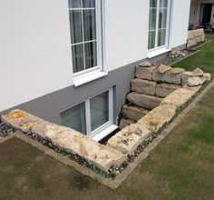 an aerial view of a house being built in the middle of a grassy area with stairs leading up to it