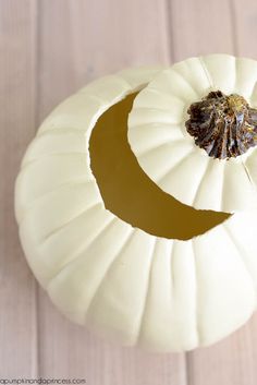 a white pumpkin sitting on top of a wooden table