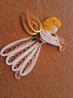 an ornament made to look like a peacock with yellow flowers on its tail