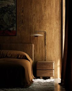 a bedroom with wood paneling and a painting on the wall