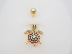 . A cute shinning gold multicolored Turtle belly ring. * Thickness: 14g . Length: 10mm (standard) * Material: Surgical steel. * Allergy free metal  . Perfect for daily wear. Please feel free to reach out to us if you have any question. Ring Piercing, Navel Piercing, Belly Button Ring, Button Ring, Belly Ring, Allergy Free, Belly Rings, Belly Button, Body Jewelry