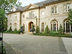 a large house with lots of windows and landscaping