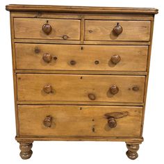 an old wooden dresser with knobs and drawers