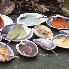 several different types of condiments sitting on the ground with sticks sticking out of them