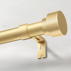 a telescope mounted on the side of a wall with a metal rod and round lens