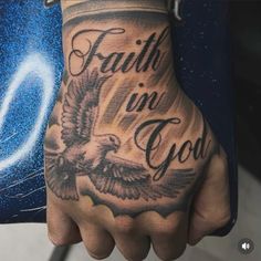 a man with a tattoo on his hand that says faith in god and an eagle