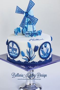 a blue and white cake with a windmill on top