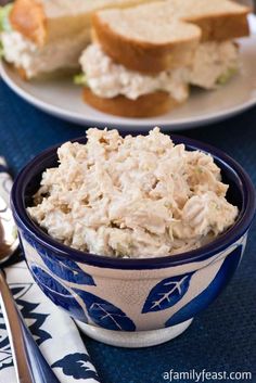 a bowl of chicken salad on a blue place mat