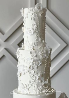 a white wedding cake with flowers on it