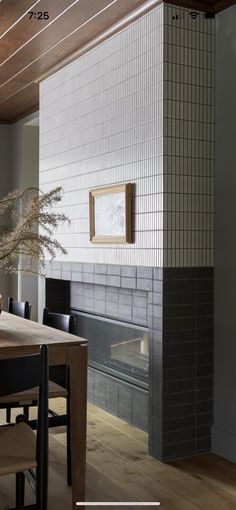 a dining room table and chairs with a fireplace in the backround behind it