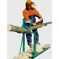 a man in an orange jacket is cutting logs