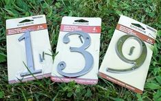 three metal numbers are laying on the grass