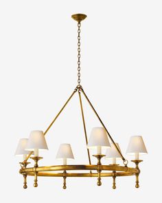 a brass chandelier with six lamps hanging from the bottom and four shades on each arm