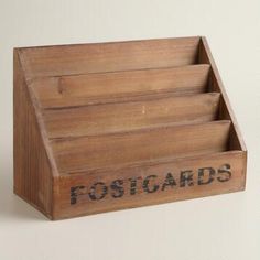 a wooden postcard holder with the word postcards written on it and two compartments for each card