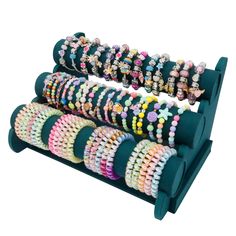 a stack of bracelets sitting on top of a stand