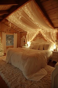 a bedroom with lights on the ceiling and a bed covered in white sheets, pillows and blankets