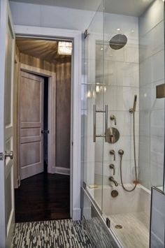 a bathroom with a walk in shower next to a door