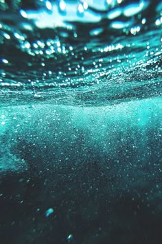 an underwater view of the ocean with bubbles