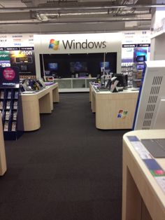 the inside of a store with computers and other electronic equipment on display in it's windows