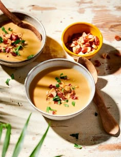 two bowls filled with soup sitting on top of a table