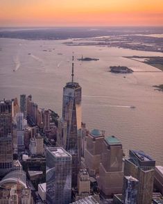 an aerial view of new york city with the empire building in the foreground at sunset