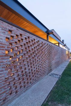 a brick wall is lit up by the light from the windows on the building's side