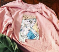 a pink shirt with patchwork on it