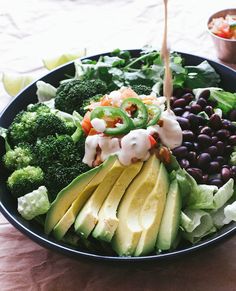 a salad with avocado, black beans and other vegetables