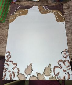 a piece of paper that has been cut out to look like flowers and leaves on it