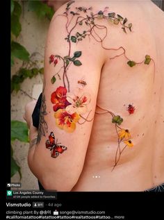 the back of a woman's body with flowers and butterflies on her left side