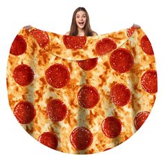 a woman is holding up a large piece of pizza with pepperoni slices on it