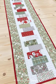 the table runner is made with red and green fabrics