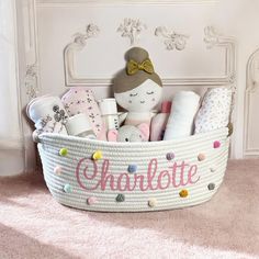 a white basket filled with lots of items on top of a pink carpeted floor