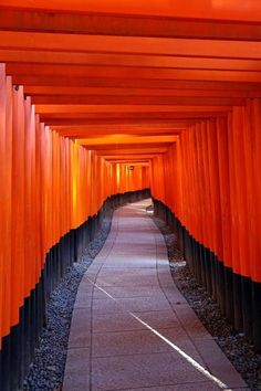 the walkway is lined with many orange columns