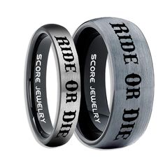 two rings with words engraved on the inside and outside, one is black and silver