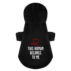 a black dog hoodie with the words,'this human belongs to me '