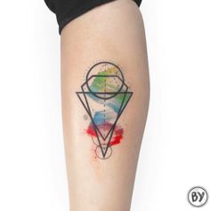 a tattoo on the leg of a woman with a diamond and paint splattered on it