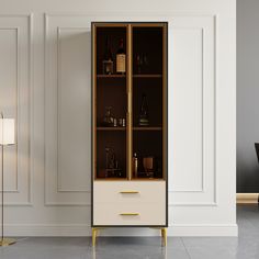 a tall cabinet with bottles and glasses on it next to a lamp in a room